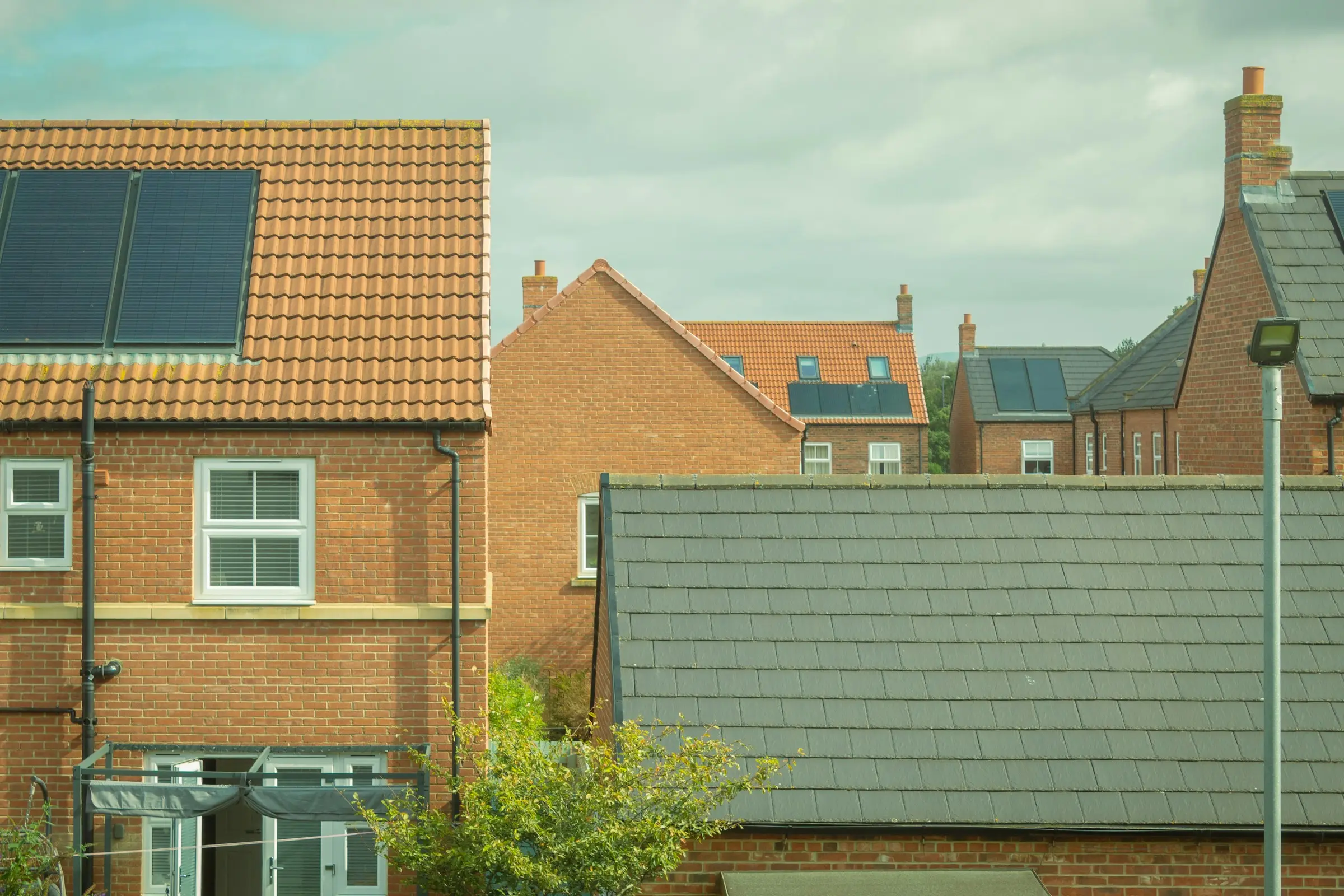 A row of houses with solar panels on their roofs