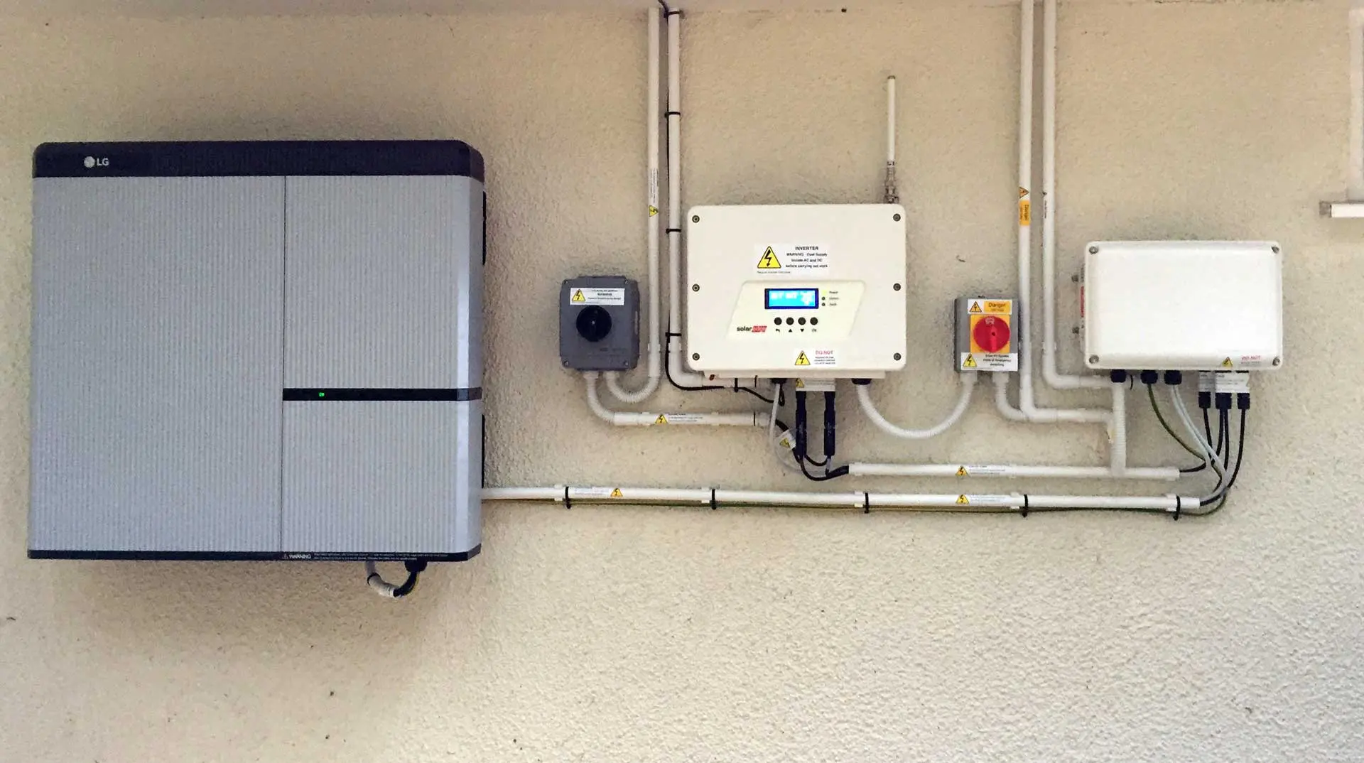 Home battery, inverter and isolator switches on a wall
