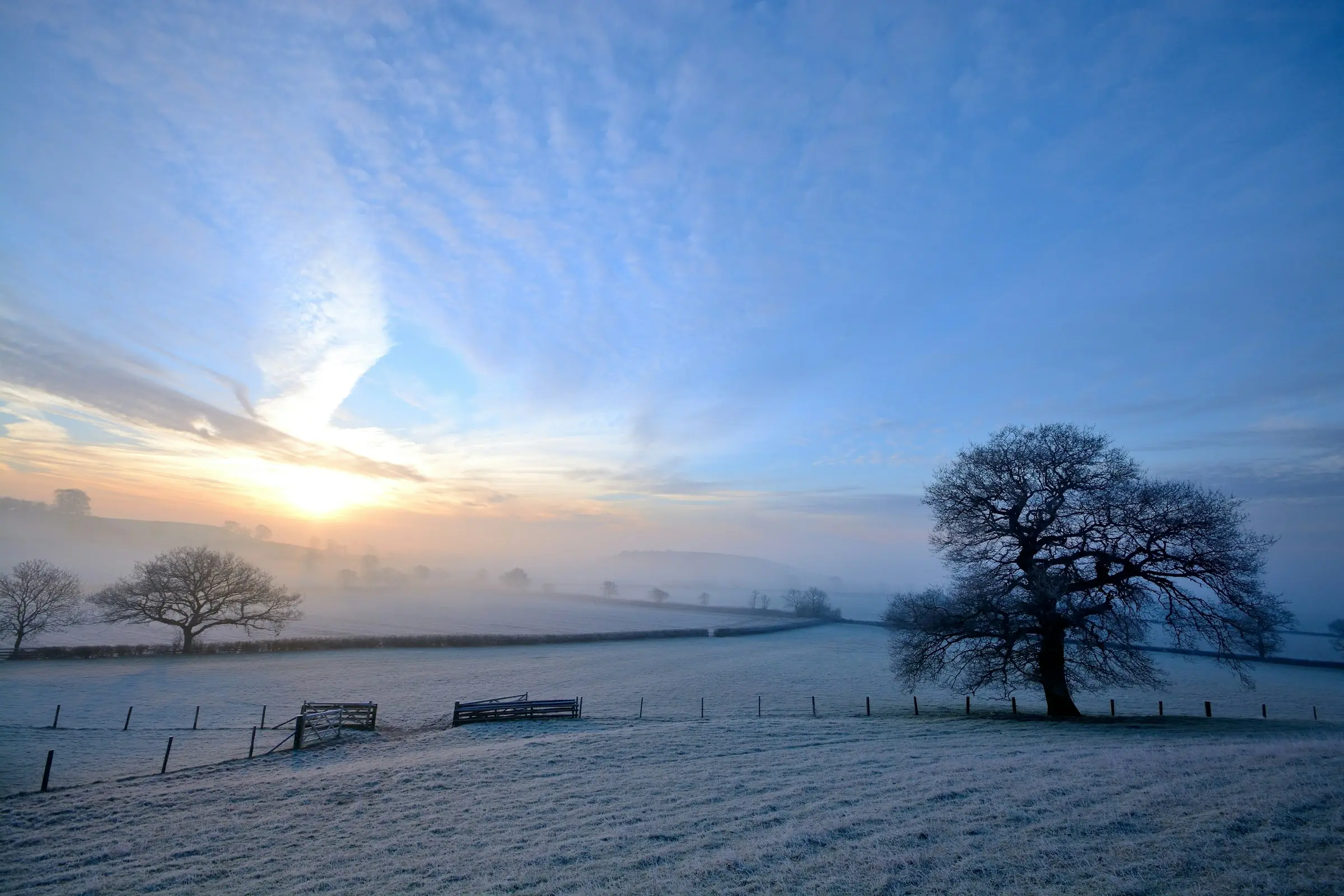 Sunrise over a frosty Cotswold hillside