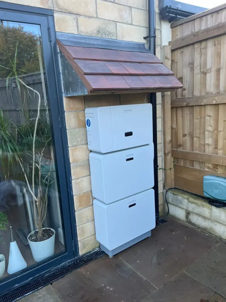 Battery storage cabinet on an outside wall beside a porch
