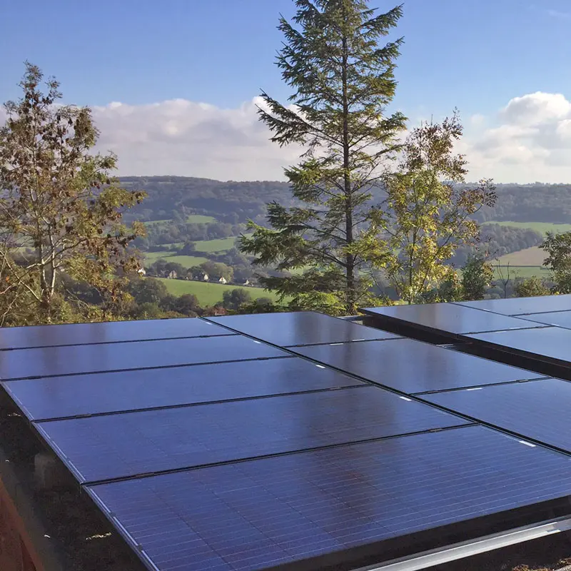 Solar panels on a roof overlooking a valley